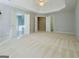 Spacious main bedroom with three open doorways, a tray ceiling, and a ceiling fan at 3195 Vickery Ne Dr, Marietta, GA 30066
