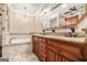 Luxurious bathroom featuring a soaking tub with mosaic tile accents, a granite countertop vanity, and a decorative chandelier at 110 Kylemore Pass, Tyrone, GA 30290