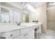Well-lit bathroom with a white vanity featuring a built-in makeup area and storage cabinets at 110 Kylemore Pass, Tyrone, GA 30290