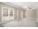 Spacious bedroom with multiple windows, neutral carpet, and a ceiling fan at 110 Kylemore Pass, Tyrone, GA 30290