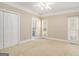 Spacious bedroom with neutral carpet, two windows, and a closet, offering a cozy and well-lit space at 110 Kylemore Pass, Tyrone, GA 30290