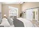 Spacious bedroom with a ceiling fan, and a door leading into an ensuite at 110 Kylemore Pass, Tyrone, GA 30290