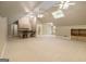 Large bonus room with a kitchenette, multiple ceiling fans, a skylight, and ample space for activities at 110 Kylemore Pass, Tyrone, GA 30290