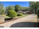 Traditional home with a long driveway, landscaped front yard, and lush green surroundings at 110 Kylemore Pass, Tyrone, GA 30290