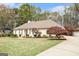 Charming ranch-style home featuring a lush front lawn, manicured landscaping, and a classic architectural design at 110 Kylemore Pass, Tyrone, GA 30290