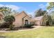 Exterior view of home featuring a well-maintained lawn and a stone pathway leading to the backyard at 110 Kylemore Pass, Tyrone, GA 30290