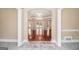 Inviting foyer with tile flooring, arched doorways, and view to hardwood living spaces at 110 Kylemore Pass, Tyrone, GA 30290