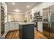 Kitchen with white cabinets, gray tile backsplash, granite countertops and stainless steel appliances at 110 Kylemore Pass, Tyrone, GA 30290