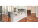 Open kitchen featuring white cabinets, granite countertops, and stainless steel appliances at 110 Kylemore Pass, Tyrone, GA 30290