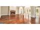 Open living space featuring hardwood floors and fireplace at 110 Kylemore Pass, Tyrone, GA 30290