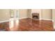 Open-concept living area featuring hardwood floors and a fireplace at 110 Kylemore Pass, Tyrone, GA 30290