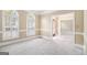 Living room with two arched windows and a doorway to another room at 110 Kylemore Pass, Tyrone, GA 30290
