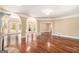 Spacious room showcasing hardwood floors and arched openings at 110 Kylemore Pass, Tyrone, GA 30290