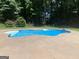 Backyard pool featuring a unique shape and concrete surround at 110 Kylemore Pass, Tyrone, GA 30290