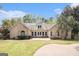 Stunning home featuring a lush green lawn, patio, and large windows providing natural light at 110 Kylemore Pass, Tyrone, GA 30290