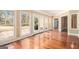 Sunroom with hardwood floors, multiple windows, and natural light at 110 Kylemore Pass, Tyrone, GA 30290