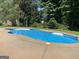 Inviting private backyard pool surrounded by concrete patio, perfect for relaxation and entertainment at 110 Kylemore Pass, Tyrone, GA 30290
