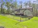 View of the backyard with chain-link fence and mature trees surrounding the property at 140 Crimson Rdg, Tyrone, GA 30290