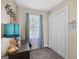 Bedroom area with a desk, window with blue curtains, closet and light beige walls at 140 Crimson Rdg, Tyrone, GA 30290