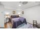Cozy bedroom featuring a bed with purple bedding, two end tables and a wood chair at 140 Crimson Rdg, Tyrone, GA 30290