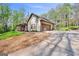 Exterior elevation of house with long driveway, lawn and manicured gravel bed at 140 Crimson Rdg, Tyrone, GA 30290