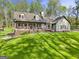 Charming exterior view of a landscaped home with a welcoming front porch and a lush green lawn at 140 Crimson Rdg, Tyrone, GA 30290
