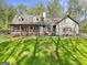Charming exterior view of a landscaped home with a welcoming front porch and a lush green lawn at 140 Crimson Rdg, Tyrone, GA 30290