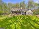 Exterior view of house with a sprawling lawn and a gazebo in the distance at 140 Crimson Rdg, Tyrone, GA 30290