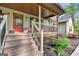 Inviting front porch with wooden steps and decorative touches, enhancing curb appeal at 140 Crimson Rdg, Tyrone, GA 30290