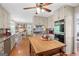 Well-lit kitchen featuring wooden floors, granite countertops, custom cabinets, and a center island with butcher block top at 140 Crimson Rdg, Tyrone, GA 30290