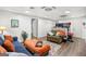 Basement living room with two sofas, an ottoman and a doorway at 140 Crimson Rdg, Tyrone, GA 30290