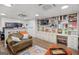 Basement living room with a chair and a built-in bookshelf at 140 Crimson Rdg, Tyrone, GA 30290