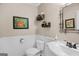 Powder room featuring a wainscotting, framed artwork, modern sink and faucet, and decor at 140 Crimson Rdg, Tyrone, GA 30290