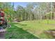The spacious, fenced backyard is surrounded by mature trees and features an outbuilding at 140 Crimson Rdg, Tyrone, GA 30290