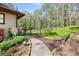 A beautifully landscaped walkway leads to a fenced yard with mature trees at 140 Crimson Rdg, Tyrone, GA 30290