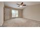 Bedroom featuring a fan, carpeted floor, and natural light from a large window at 11419 South Grove Dr, Hampton, GA 30228