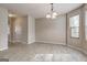 Open dining space with overhead chandelier, window, and connecting doors offering flexible living and entertaining at 11419 South Grove Dr, Hampton, GA 30228
