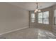 Inviting dining area illuminated by a chandelier, featuring several windows that fill the space with natural light at 11419 South Grove Dr, Hampton, GA 30228