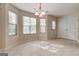 Cozy dining area with chandelier, multiple windows, and a convenient door offering a bright and airy space at 11419 South Grove Dr, Hampton, GA 30228