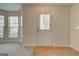 Front door and window-lined wall illuminate the entryway with natural light, complemented by wood-style flooring at 11419 South Grove Dr, Hampton, GA 30228