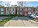 Street view of townhomes with varied exteriors, showcasing landscaping and parking spaces at 11419 South Grove Dr, Hampton, GA 30228