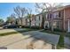 Exterior view of a row of townhomes showing driveways and manicured lawns at 11419 South Grove Dr, Hampton, GA 30228