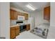 Functional kitchen with wood cabinets, white appliances, double sink, and ample counter space for meal preparation at 11419 South Grove Dr, Hampton, GA 30228