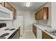 Well-equipped kitchen featuring bright white appliances, wood cabinetry, and a practical layout for efficient cooking at 11419 South Grove Dr, Hampton, GA 30228