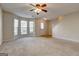 Inviting living room with carpet, large windows and staircase at 11419 South Grove Dr, Hampton, GA 30228