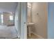 Pedestal sink and oval mirror adorn this convenient powder room, complemented by neutral walls and tile floor at 11419 South Grove Dr, Hampton, GA 30228