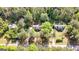 Overhead shot displays the home, its position relative to the road, and mature trees at 653 Locust Rd, Locust Grove, GA 30248