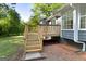 A wooden deck with stairs offers outdoor living space and backyard access at 653 Locust Rd, Locust Grove, GA 30248