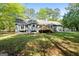 Exterior view of the home's backyard, wooden deck and well-maintained lawn at 653 Locust Rd, Locust Grove, GA 30248