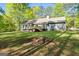 Backyard with a wooden deck and a cozy fire pit area at 653 Locust Rd, Locust Grove, GA 30248